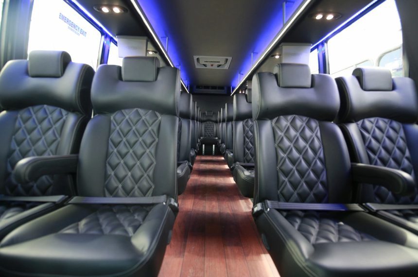 A bus with black seats and blue lights
