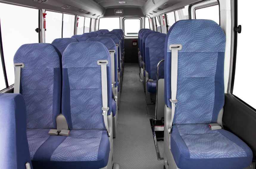 A bus with blue seats and white trim.